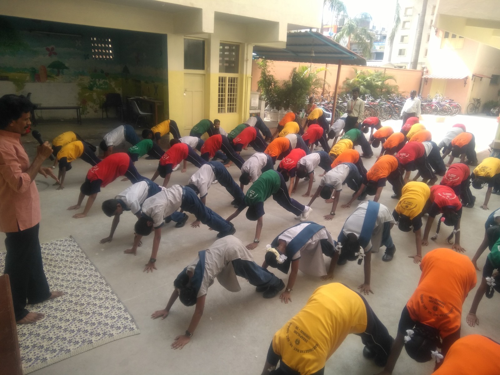 Students practising yoga together in the school courtyard