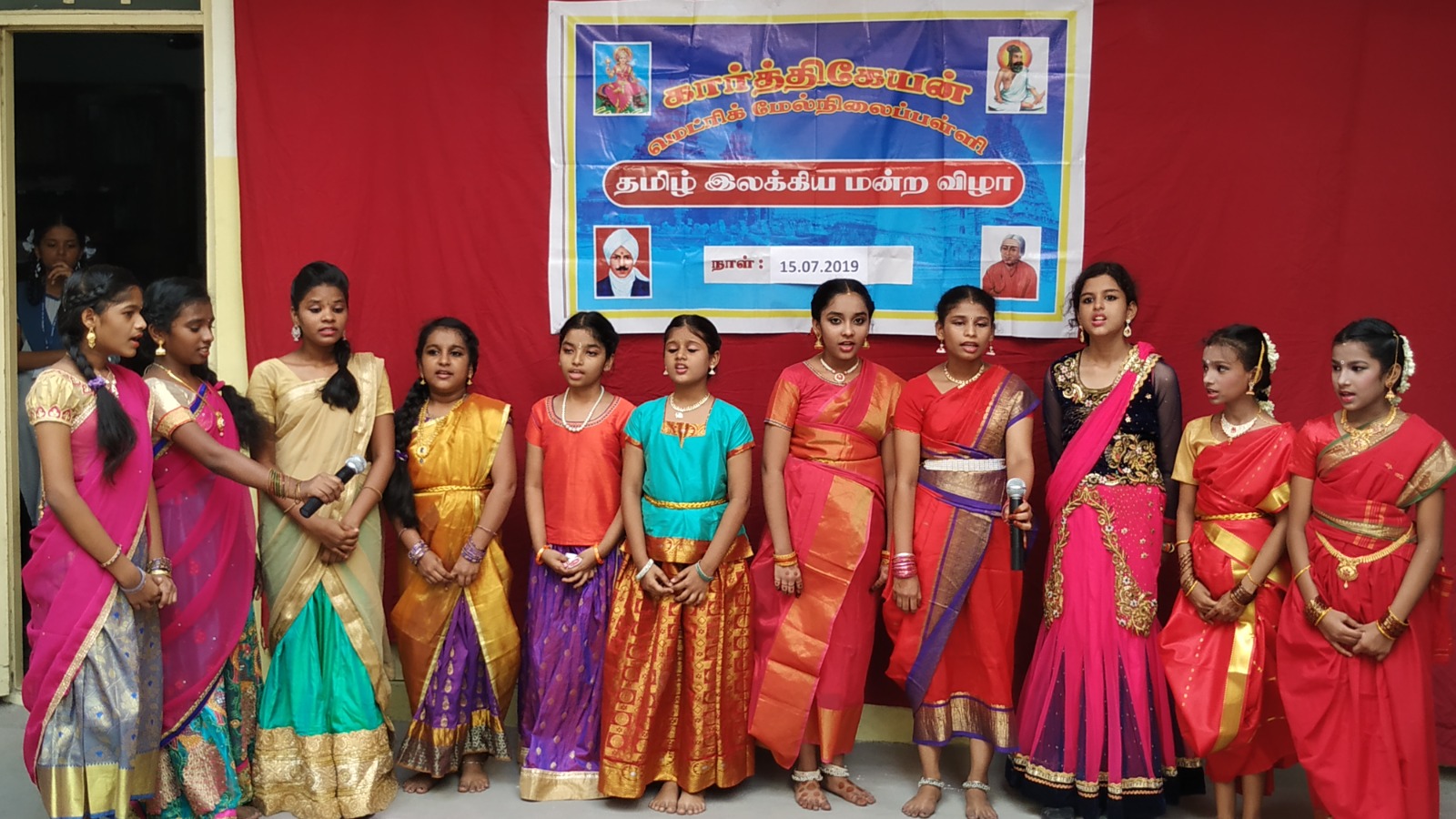 Students in traditional attire performing at a cultural event